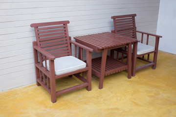 wooden chair on yellow cement floor with mortar wall background