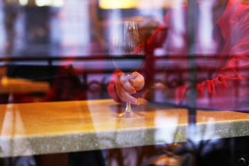 Woman with glass of wine in restaurant