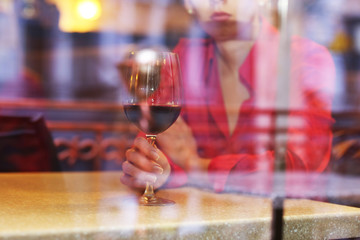 Woman with glass of wine in restaurant