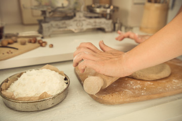 Woman hands kneading dough on the table