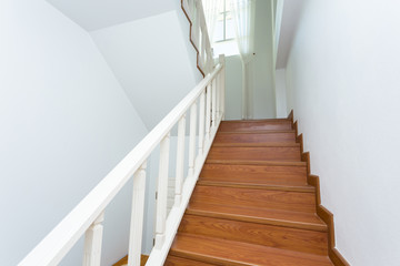 wooden staircase made from laminate wood in white modern house