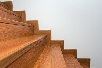 wooden staircase made from laminate wood in white modern house