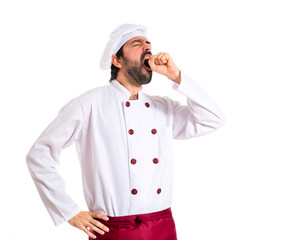 Chef yawning over white background