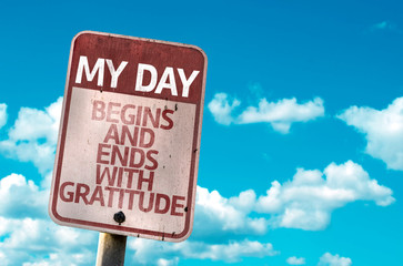 My Day Begins and Ends With Gratitude sign with sky background