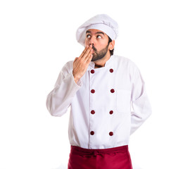 Chef doing surprise gesture over white background