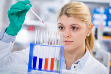 young women science professional pipetting sol