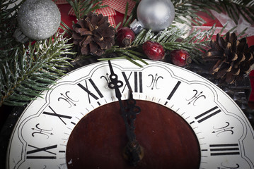Christmas clock and fir branches covered with snow