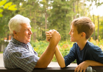Grandfather and grandson in the park
