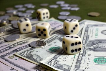 White Dices,Coins and American Dollar Banknotes on Green Table