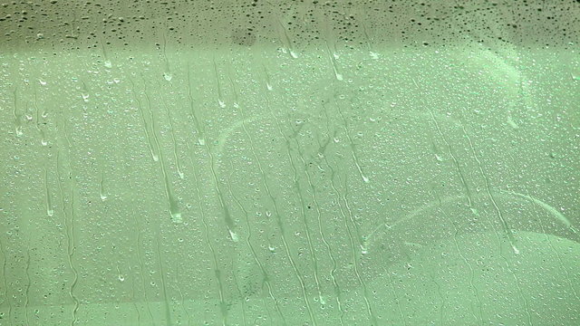 Rain drops falling on car window 02
