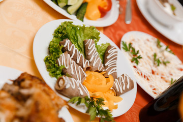 Dish with sliced meat rolls
