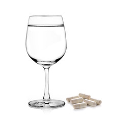 glass of water and pills capsules isolated on white background