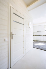 White, wooden door in modern house