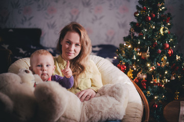 Obraz premium Mother and little son at home near Christmas tree