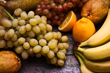 Assorted fruits still-life on the purple background