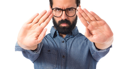 Young hipster man making stop sign