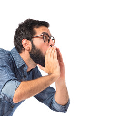 Young hipster man shouting over white background