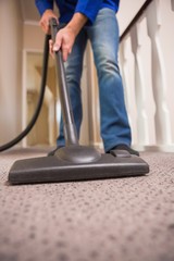 Fototapeta premium Close up a young man vacuuming