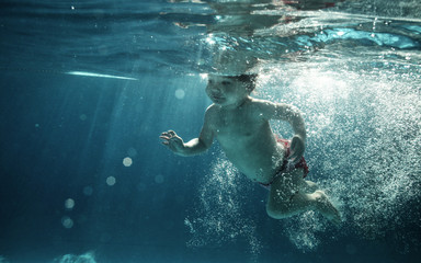 Fototapeta na wymiar baby in water park swimming underwater