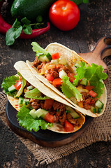 Mexican tacos with meat, vegetables and cheese