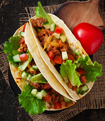 Mexican tacos with meat, vegetables and cheese