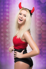 female go go dancer.  girl wearing devil horns