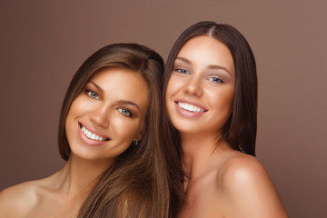 Portrait of two Beautiful Women with Long Hair and Clean Skin