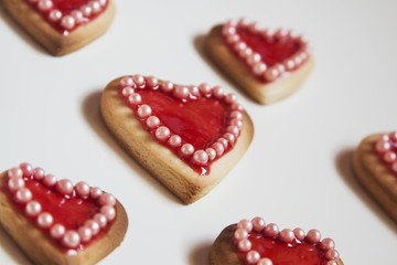 Red hearts cookies on white background