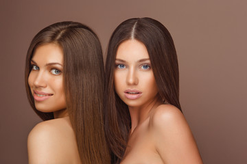 Portrait of two Beautiful Women with Long Hair and Clean Skin.
