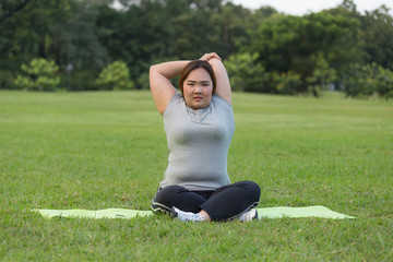 Fototapeta premium obese women yoga on grass