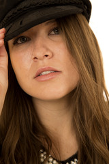 Woman hand on black hat with a serious look