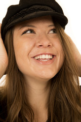 Cute woman wearing a black hat looking up smiling