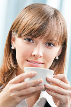 Businesswoman with cup of coffee at office