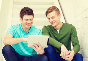 smiling male students with tablet pc computer