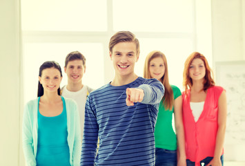 students with teenager in front pointing at you