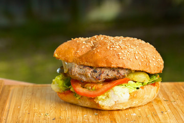 Tasty burger with melted cheese and thick succulent ground beef