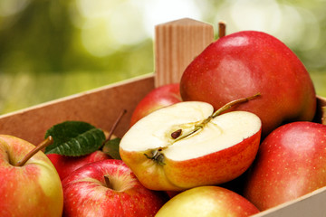 Fresh red apples on wooden table