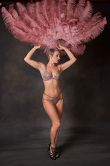 Burlesque dancer holding feather fans up