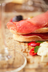 meat platter of Cured Meat and olives on old wooden board
