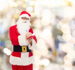 man in costume of santa claus with notepad