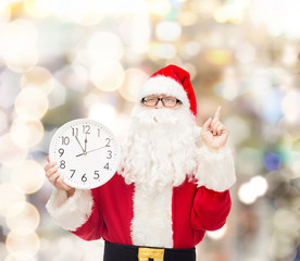 man in costume of santa claus with clock