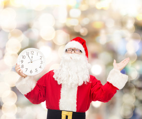 man in costume of santa claus with clock