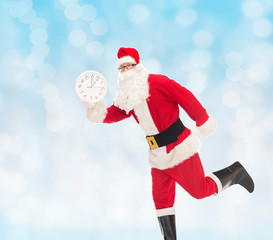 man in costume of santa claus with clock