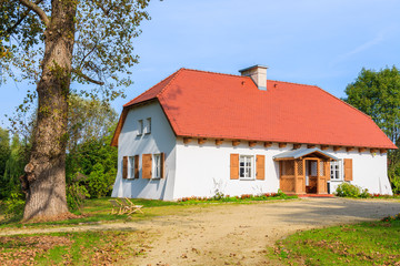 Traditional cottage house in countryside landscape of Poland