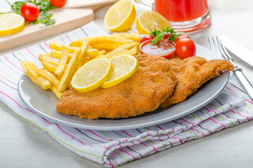 Schnitzel with french fries and a spicy dip