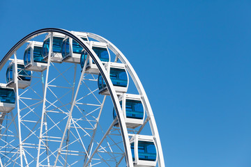 Ferris wheel on blue sky background