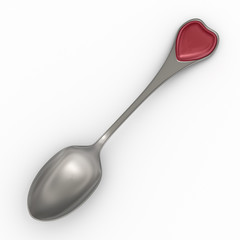 Silver spoon with heart emblem on handle