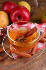 Apple cider with cinnamon sticks and fresh apples