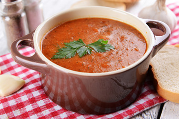 Delicious lentil cream-soup on table close-up