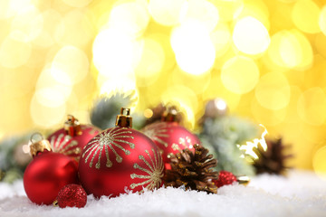Fototapeta na wymiar Christmas balls on snow on bright background